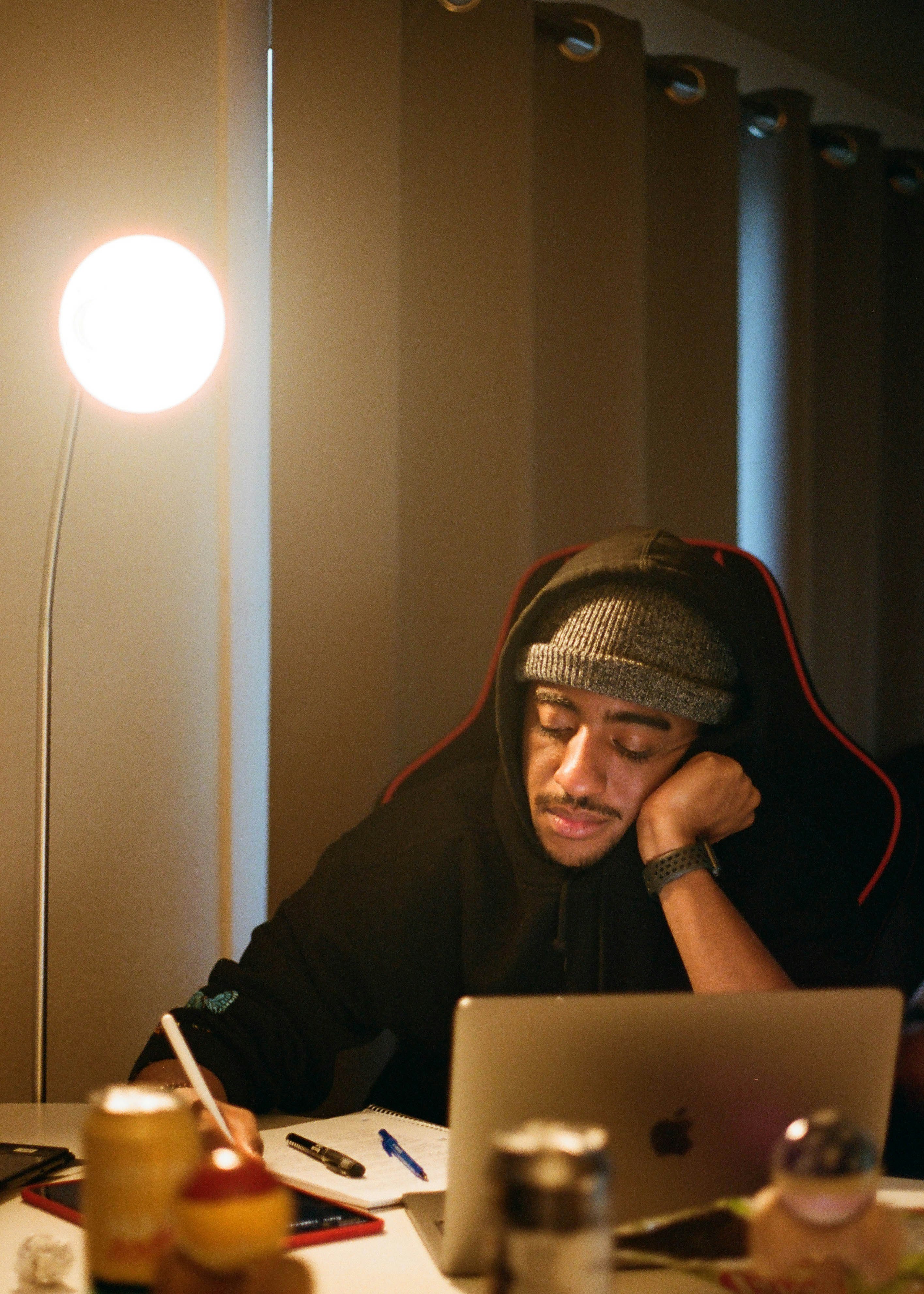 man in black hoodie using macbook